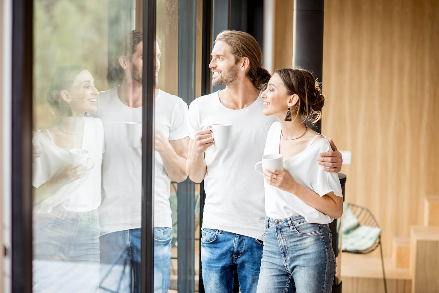 couple looking out of aluminium bi-folding doors